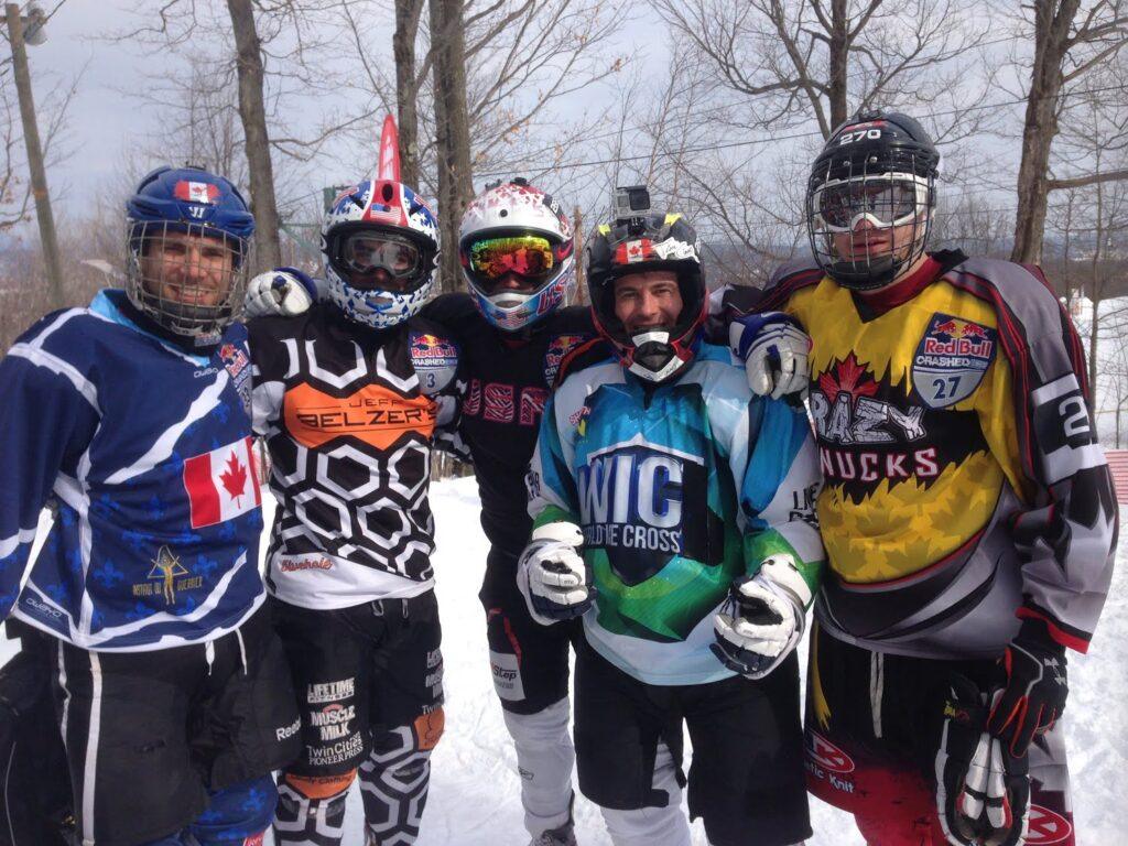 A group of individuals standing together in the snow, showcasing the excitement of an ice cross event.